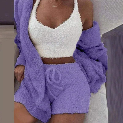 Person wearing a Womens Comfortable Knit Pajama Set white fuzzy top and purple fuzzy shorts with a matching cardigan.