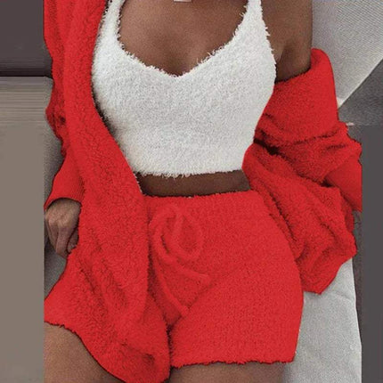 Person wearing a red Womens Comfortable Knit Pajama Set fleece outfit with a white top.
