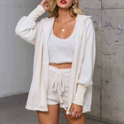 Woman wearing a white Womens Comfortable Knit Pajama Set with a hood against a gray wall.