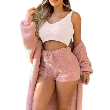 Woman wearing a pink Womens Comfortable Knit Pajama Set, white top, and pink shorts on a white background