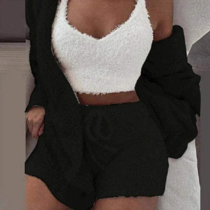 Person wearing a Womens Comfortable Knit Pajama Set white textured top and black shorts with a blurred background