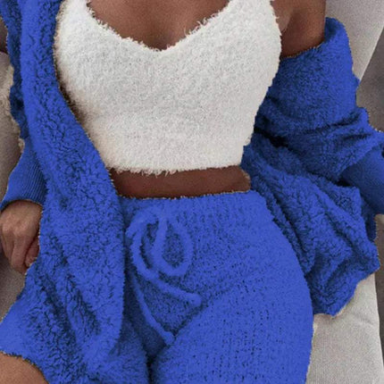 Person wearing a Womens Comfortable Knit Pajama Set blue and white textured outfit with a blanket draped over them.