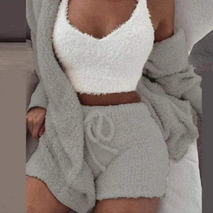 Person wearing a Womens Comfortable Knit Pajama Set white fuzzy top and gray shorts with a matching robe.