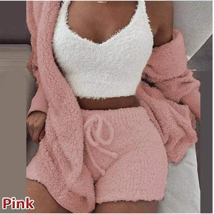 Person wearing a pink Womens Comfortable Knit Pajama Set fuzzy robe and white fuzzy top with matching shorts.