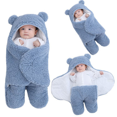 Blue baby sleeping bag with bear ears and feet on a white background