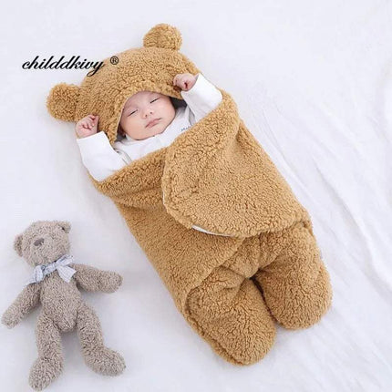 Baby wrapped in a brown Baby Wrap Blankets Swaddle Cozy, Gentle, and Multi-Functional with a matching teddy bear on a white background.