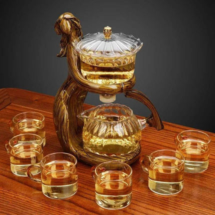 Semi-Automatic Teapot elegantly brewing tea with matching cups on a wooden table.