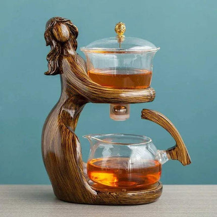 Semi-Automatic Teapot elegantly designed with an artistic figure, showcasing brewed tea for a stylish tea experience.