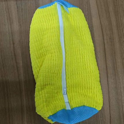 Yellow and blue Shoe Washing Machine Bag 360° Deep Cleaning & Footwear Protection on a wooden surface
