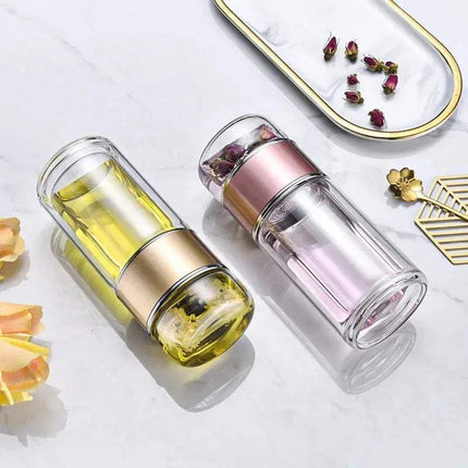 Tea Infuser Bottle with metal accents on a light surface with decorative elements.