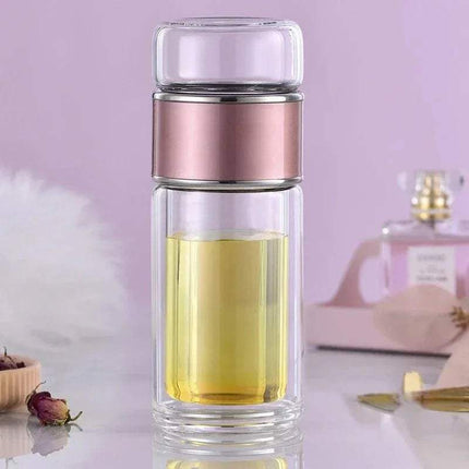 Tea Infuser Bottle with pink metal top on a light purple background