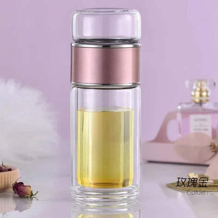 Tea Infuser Bottle with pink metal top on a light purple background