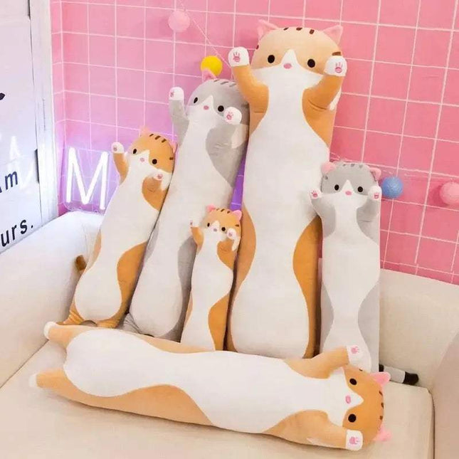 Set of a Long Cat Pillow on a couch with a pink checkered wall in the background
