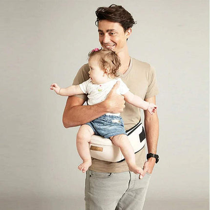 Father using Ergonomic Baby Waist Seat to carry baby comfortably while smiling.