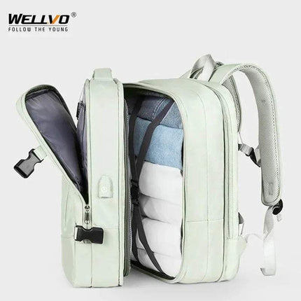 green Extendible Travel Backpack Unisex with open front compartment showing organized items on a white background, featuring the WELLVO brand.