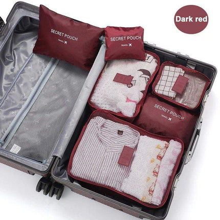 Set of dark red 6Pcs Travel Clothes Storage Bags labeled 'Secret Pouch' inside an open suitcase.
