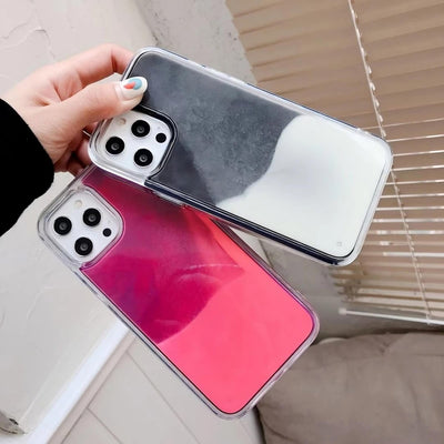 Two phone cases, one black and one red with pink gradient, held by a hand.