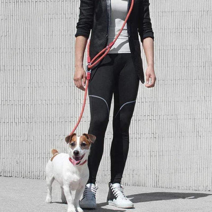A person walking a dog with a Reflective Hands-Free Nylon Leash for Pets, showcasing comfort and visibility.
