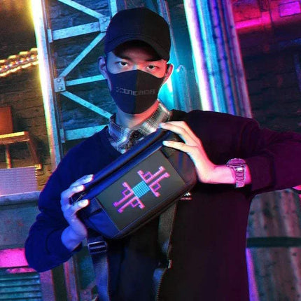 Person holding a futuristic Sling Bag with LED Display Bluetooth Programmable LED Fanny Pack with digital display in a neon-lit setting