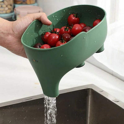 Green 2x Elephant Drain Baskets Cute & Functional Kitchen Sink Strainers with tomatoes being rinsed under running water in a kitchen sink.