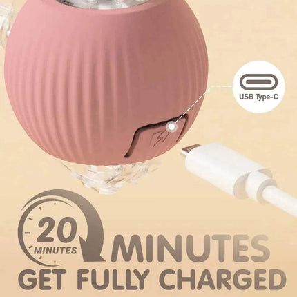 Pink Automatic Rolling Ball Cat Toy  with USB Type-C cable on a beige background