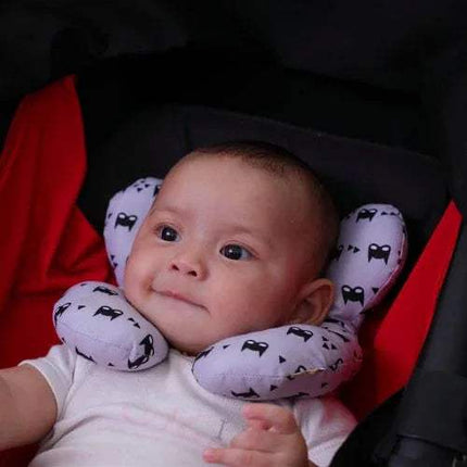 Baby wearing a purple Baby Travel Pillow Safe, Comfortable Head & Neck Support with black patterns in a baby stroller.