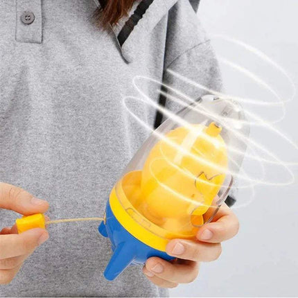 Person holding a yellow and blue Egg Yolk Shaker Mixer Spinner Perfectly Blend Eggs in Seconds with a clear cylindrical container.