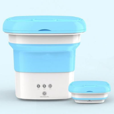 Collapsible silicone food container with blue lid on a light gray background