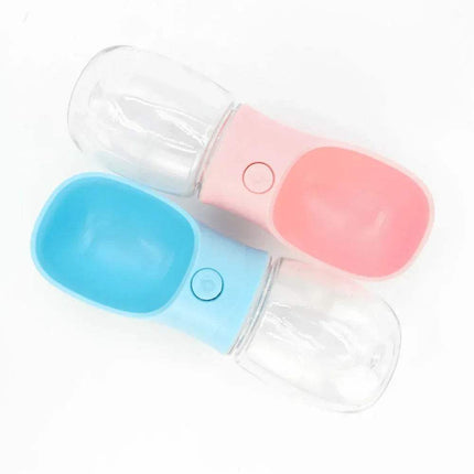 Portable Pet Water Drinking Bottle in blue and pink colors, featuring one-press hydration design.
