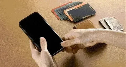 Person using a 2 in 1 Detachable iPhone Leather Case Wallet, removing the phone as cards are nearby.