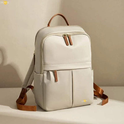 Ivory CFUN YA Luxury Backpack for Women with brown straps on a beige background