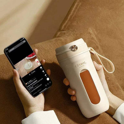 10 Blades Electric Portable Blender with a brown interior and a smartphone on a brown surface.