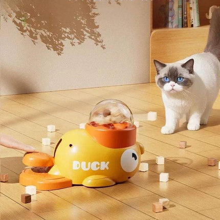 Automatic Interactive Pet Feeder in the shape of a duck, engaging a curious cat in playful snack dispensing.