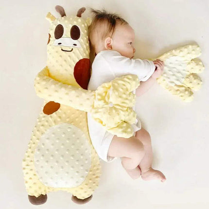Baby holding a Baby Pat Pillow Gentle Soothing Sleep Companion for Babies & Toddlers plush toy on a plain background