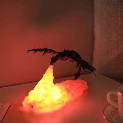 Decorative lamp shaped like a dragon with a glowing yellow base on a table.