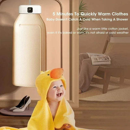Baby wrapped in a yellow towel with duck design, standing in a living area next to a Electric Travel Clothes Dryer.