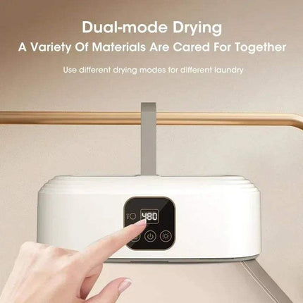 Electric Travel Clothes Dryer with digital display and hand interacting with it, set against a beige background.