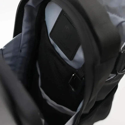 Close-up of a black Magnetic Water Bottle Bag featuring its inside compartment on a white background