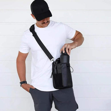 Man holding a black Magnetic Water Bottle Bag for Hands-Free Hydration against a white background