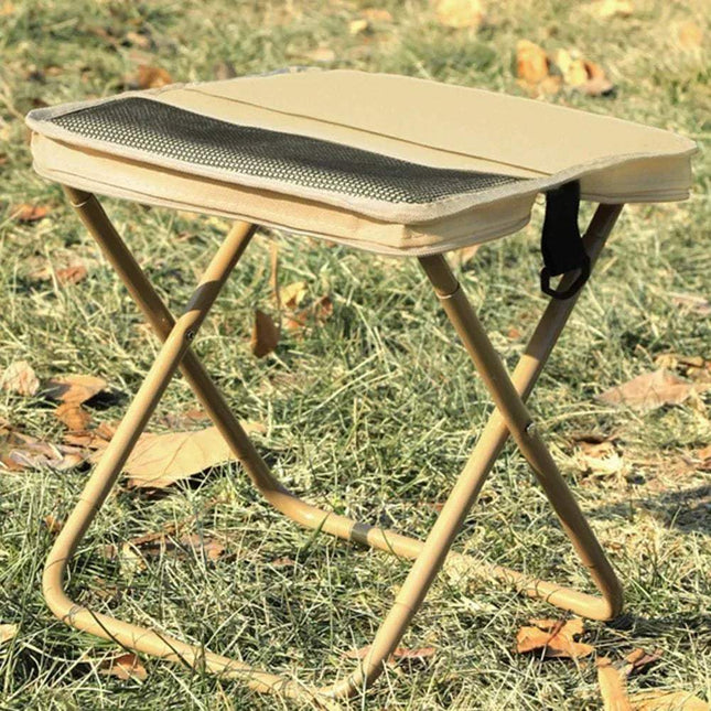 Foldable Backpack Stool on grass, perfect for outdoor adventures and portable seating.