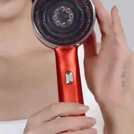 Electric Scalp Massager held by a person, designed for hair growth and relaxation.