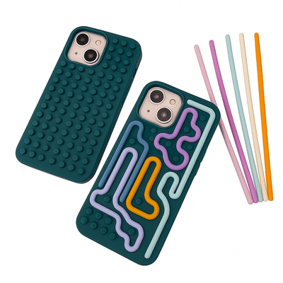 Two phone cases, one with a textured surface and the other with colorful geometric design, alongside colorful straws on a white background.