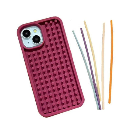 Stress-Relieving Phone Case in pink color with tactile bumps, accompanied by colorful fidget sticks.