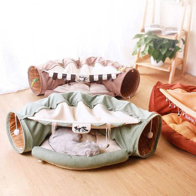 Pet play area with Pet Cats Tunnel Toy and a cushion on a wooden floor.