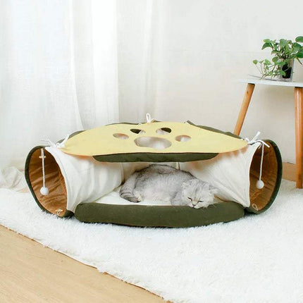 Cat lying inside Pet Cats Tunnel Toy on a white floor.