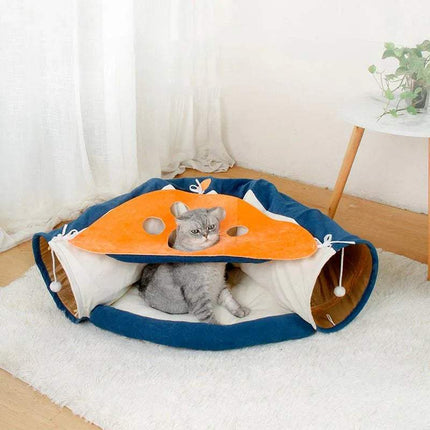 Cat lying inside Pet Cats Tunnel Toy with an orange top and blue sides on a white rug.