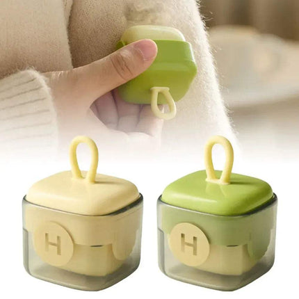 Portable Fur Remover Reusable Pet Hair & Lint Cleaner held by a hand, with a blurred background.