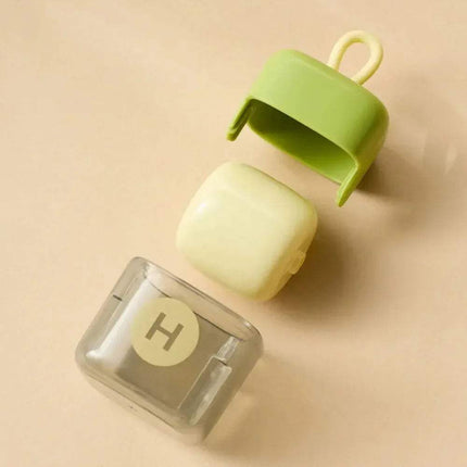 Portable Fur Remover with a lid on a beige background