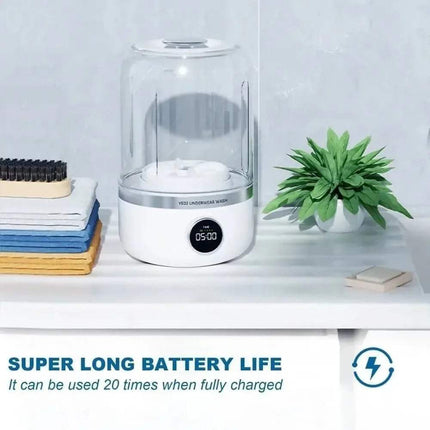 Portable Mini Washing Machine with digital display on a white surface with a plant and books in the background.