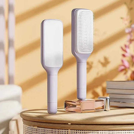 Two Self-Cleaning Hairbrush Hassle-Free Grooming & Smooth Styling on a wooden surface with a blurred background